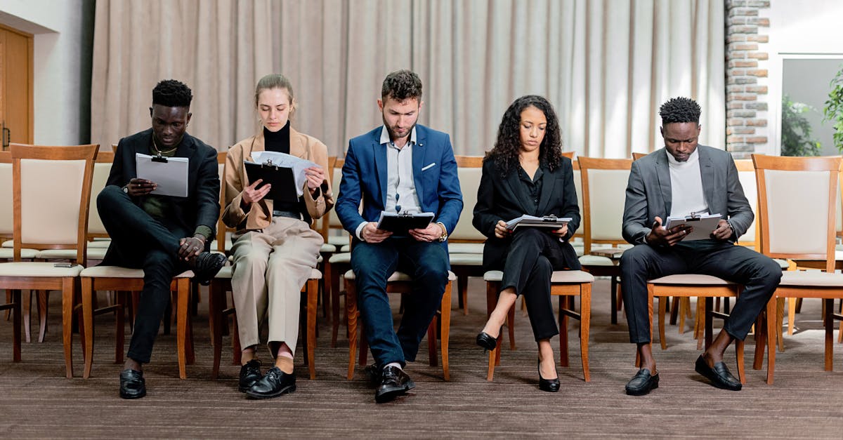 A diverse group of professionals attentively reviewing documents indoors.
